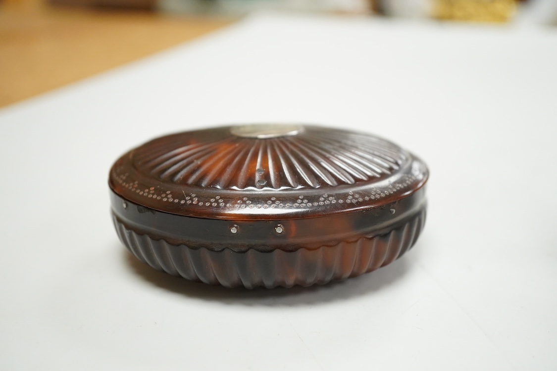 An 18th century tortoiseshell oval fluted snuff box, 89mm and a George V silver and tortoiseshell mounted trinket box, London, 1916.